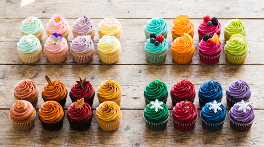 Four groups of frosted cupcakes in spring, summer, autumn and winter color palettes