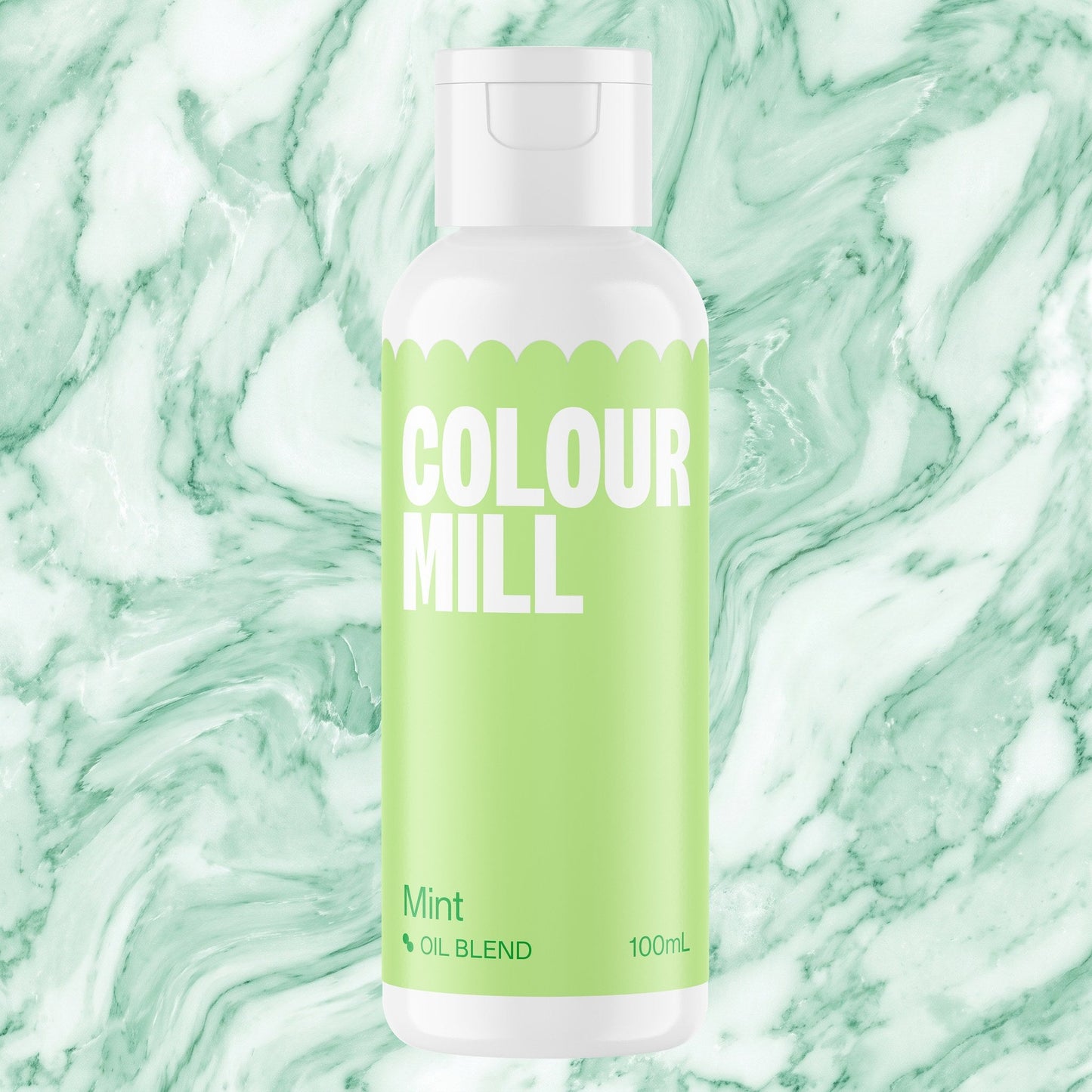 Colour Mill Mint 100ml oil based food coloring bottle on a marbled background