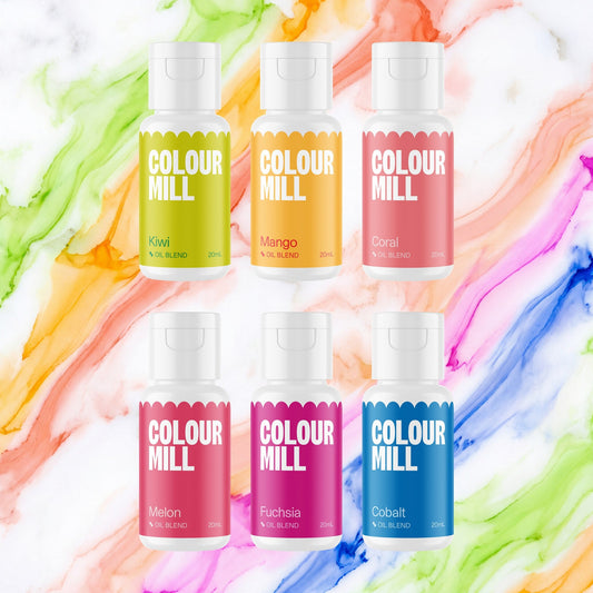 Colour Mill Tropical Pack of 6 20ml oil based food coloring bottles on a soft tropical watercolour marble background